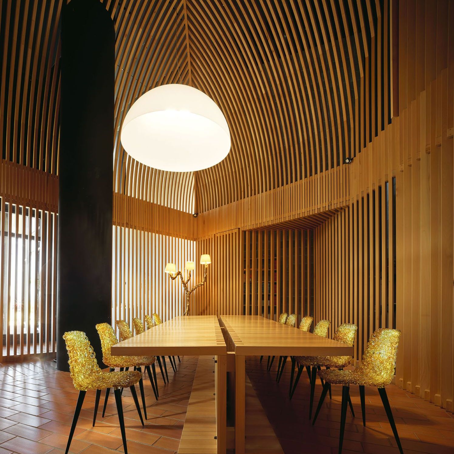  Gina and Ines.&nbsp;Next page, the chairs and lamp with their reflections illuminate the wood and brick interior in one of the winery&rsquo;s rooms. 