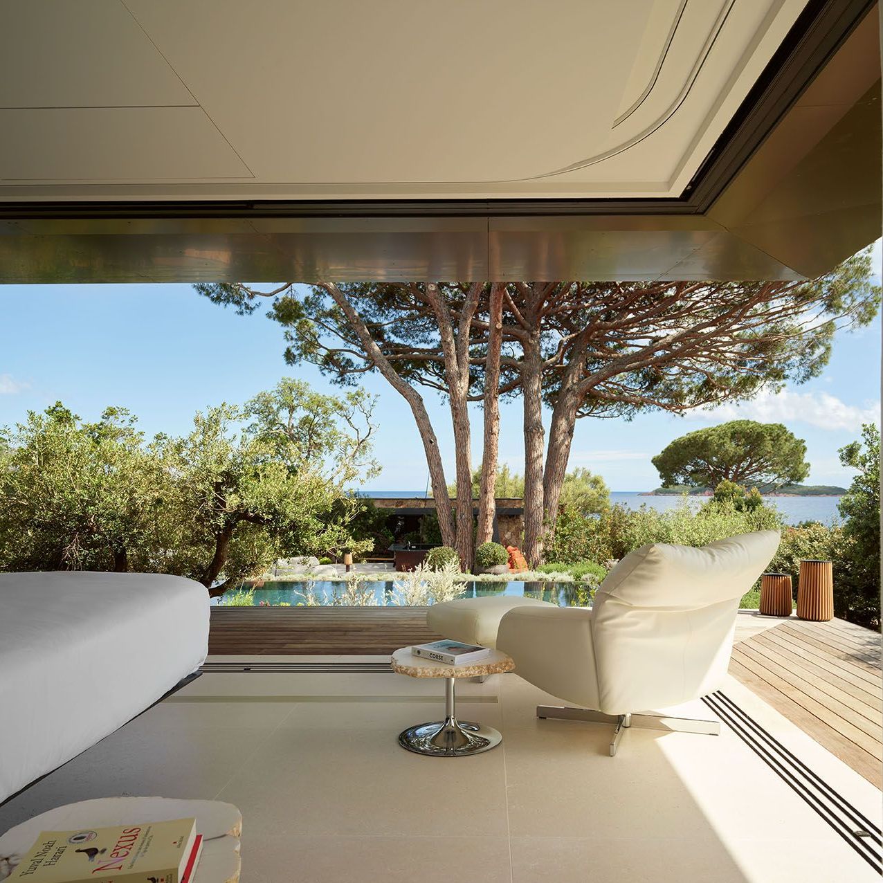   Chiara and Cicladi.  The white leather armchair and the side table create a quiet corner overlooking the horizon. 
