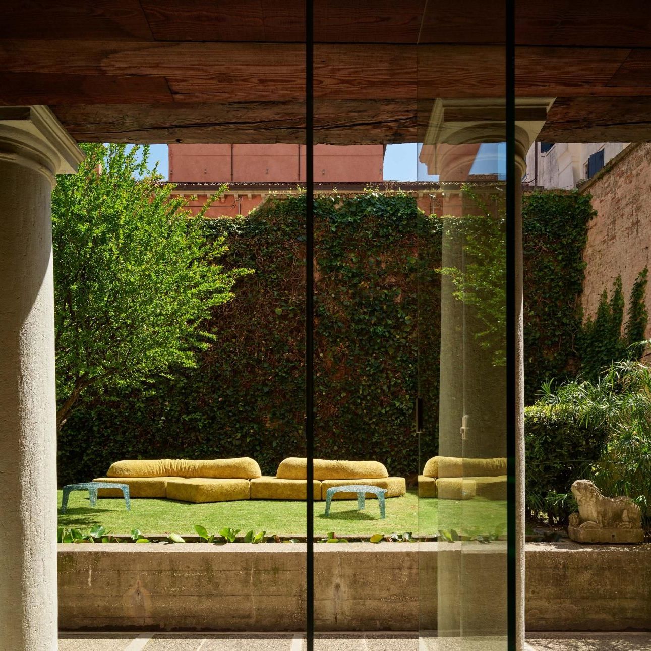  On the Rocks Outdoor and Veronica. 
The sofa upholstered in Royal Yellow Every Stone and the coffee tables in the garden designed by Carlo Scarpa. 