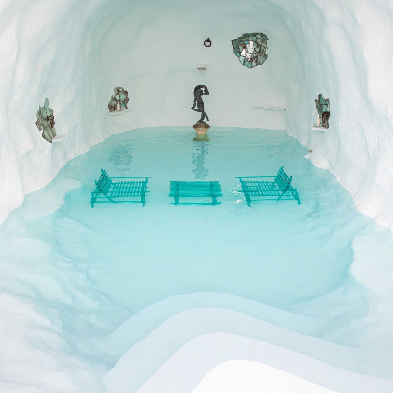   A'mare . The Chairs and the Table, of the Same Shade of Blue of the Water, created at Relaxation Area Immered in The White Cave Tank. 