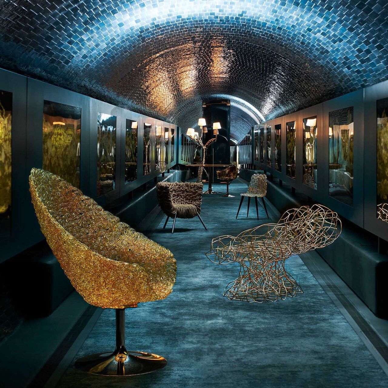 The Edra models inside the Rifugio Digitale in Florence. In a special setting, Margherita, Corallo, Vermelha, Gina, Ella, Egeo, Ines in shades of gold, amplify the expressive power of Fabrizio Plessi&rsquo;s ORO work, the first exhibition of the Crypto Art gallery 