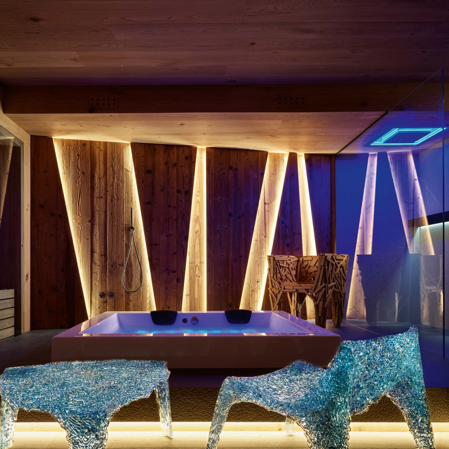   Veronica   collection  and  Favela . The armchairs and table harmonize with the colors and materials of the spa interiors and the large whirlpool tub. 
