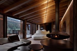   Pack ,  Flap  and  Cicladi . The sofas and tables furnish the living area developed around a large suspended sculpture-fireplace, offering a dual view of the interiors and the landscape. In the background, the Favela armchair on the terrace. 